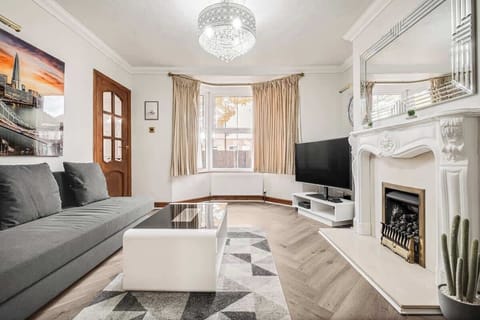Spacious and stylish lounge with a comfy sofa and large TV – your go-to spot for laid-back evenings