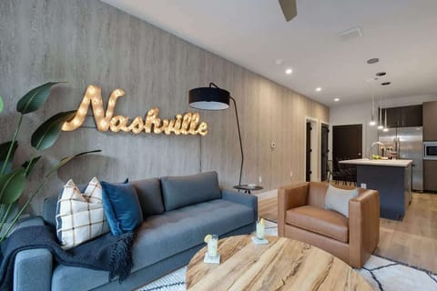 Bright living room with comfortable seating, smart TV, designer decor, and access to the private patio.