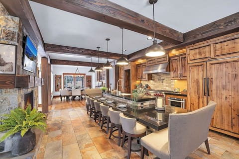 The kitchen boasts sushi bar-style seating for ten, making it a perfect place for family and friends to gather, dine, and share unforgettable meals.