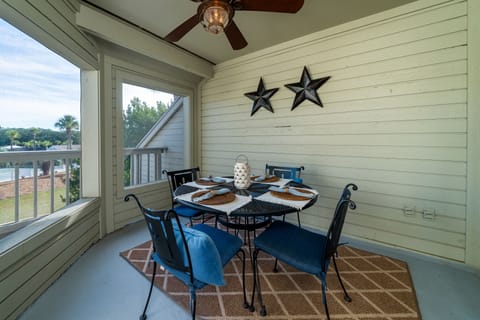 The screened porch has a table with seating for four. Enjoy watching the tennis platers on Center Court