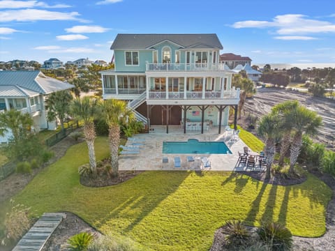 Stunning coastal vacation home with private pool, multiple decks, and beach access in a peaceful residential neighborhood.
