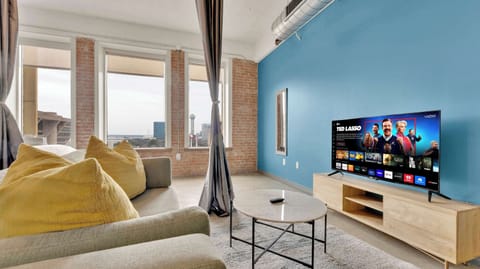 Living Room: Stunning city views with vibrant decor and modern entertainment for fun-filled evenings!