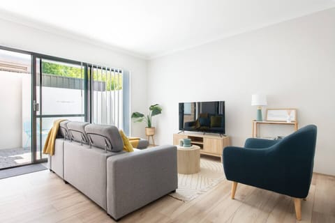 Modern living space with a comfy couch and entertainment setup.