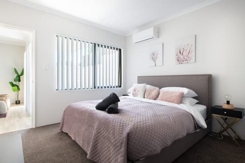 This well-appointed bedroom offers a cozy queen bed, individual air-conditioning, and direct access to your private ensuite.
