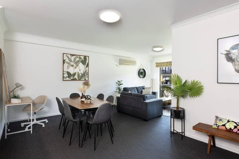 This inviting space combines a dining table for six, a cozy sofa lounge, and a designated desk for productivity.