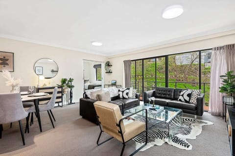 Spacious open-plan living and dining area with comfortable seating and lovely garden views.