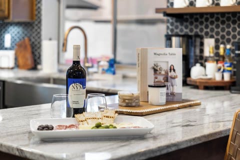 Inviting kitchen setup with wine and charcuterie for a delightful evening.