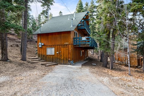 Side of cabin - Adorable 3-level ski chalet with 3 decks in upper Moonridge. Nestled in the woods NEXT to Bear Mountain Slopes!