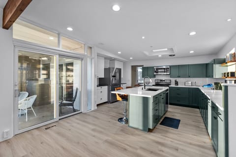 Fully stocked kitchen and access to the covered back patio and grill