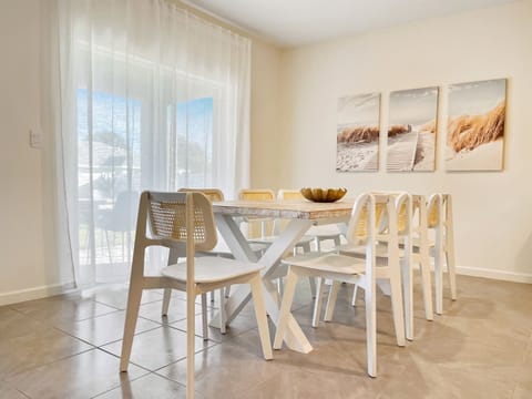 [Dining Room] Dining with sliding doors to the covered patio and backyard