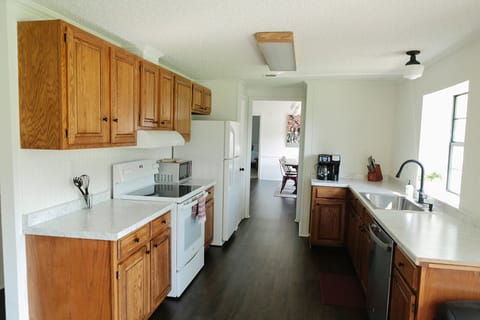 Oven side of kitchen and view of 1/2 dining rooms.