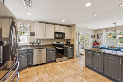 Kitchen with stainless steel appliances and is fully stocked.