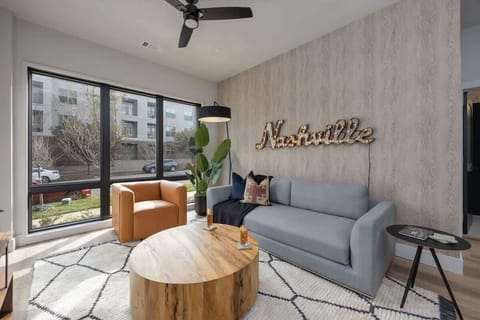 Bright living room with comfortable seating, pull out sofa, smart TV, complete with designer decor.