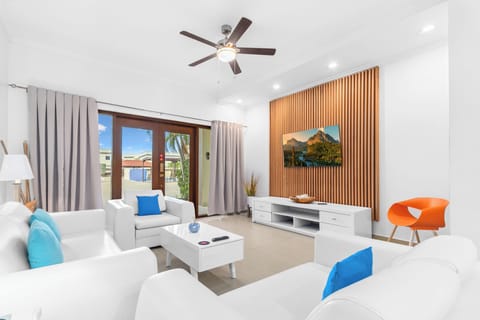 Magnificent Living Area of the 2BR Condo in Noord Aruba - Living room area with sliding door for easy access to pool - Smart TV and Netflix - Comfy Seating Arrangements