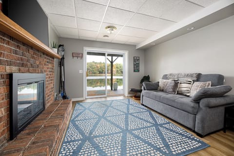 Relax in the bright living room w/ plush sofa sleeper, fireplace, & sliding doors to the deck.