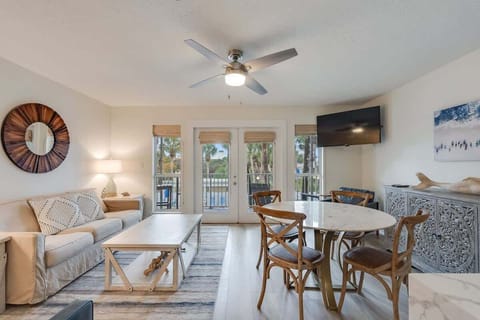 - Soak in palm lined views through bright French doors as sunlight warms the room - Curl up on the plush sofa, stream your favorites, or dine with friends at the round table - Breezy, beachy, and built for laid back moments and good vibes
