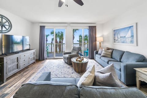 Sink into coastal comfort in your spacious living room, where ocean breezes flow through your private balcony.