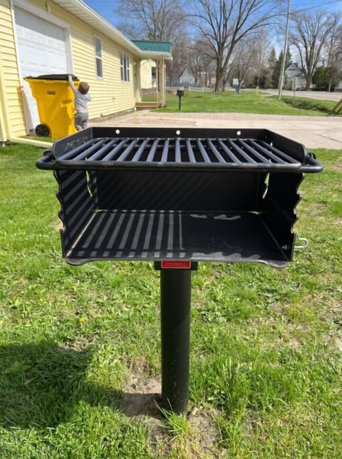 Charcoal grill outside the front door of the cabin.