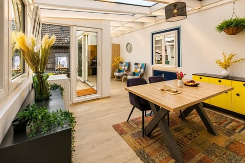 Enjoy meals, conversations, and quality time in this spacious dining area featuring modern décor, comfortable seating, and a charming open-concept layout.