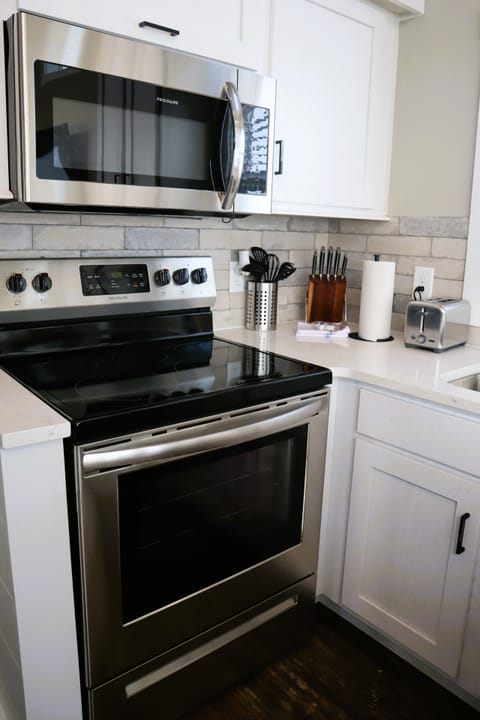 Full kitchen with microwave, stove, dishwasher, fridge, washer and dryer