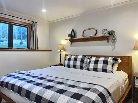 Cozy king bedroom with stunning views through the big window.