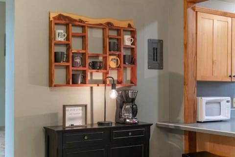 Coffee station with coffee pot, mugs, and filters.