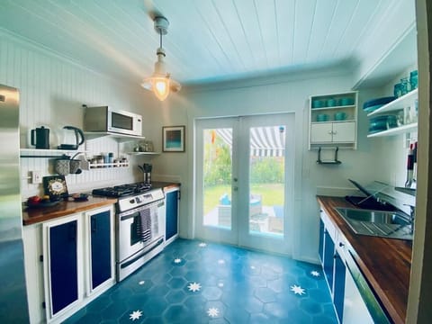 Full-size kitchen with gas stove that opens onto back yard