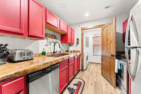 Fully stocked kitchen with dishwasher, stove and refrigerator. 