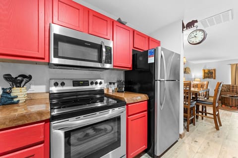 Fully stocked kitchen with a stove, dishwasher and refrigerator.