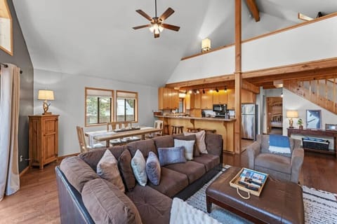 Relax with your loved ones in the comfortable living room, outfitted with a plush l-shaped sectional and an oversized chair situated around an electric fireplace. The fireplace is currently out of order.