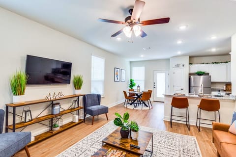 Step into a sunlit living room featuring a plush sofa, smart TV, and chic décor—a cozy spot to relax, binge your favorite shows, or enjoy time with friends and family.