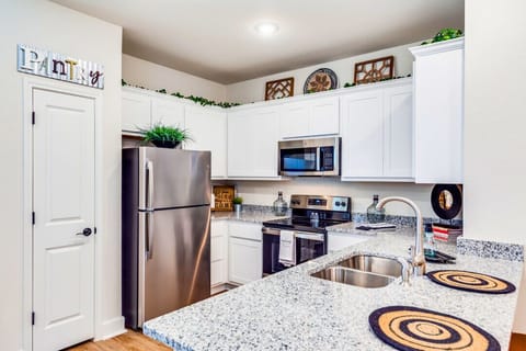 Cook up your favorite meals in a bright, well-equipped kitchen featuring modern appliances, plenty of counter space, and a built-in heater—comfortable and cozy all year round