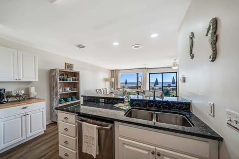 The fully equipped kitchen features granite countertops and stainless-steel appliances.