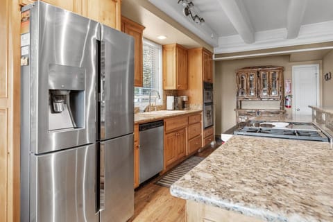 Bright kitchen w/ stainless appliances & generous counter space for easy meal prep.