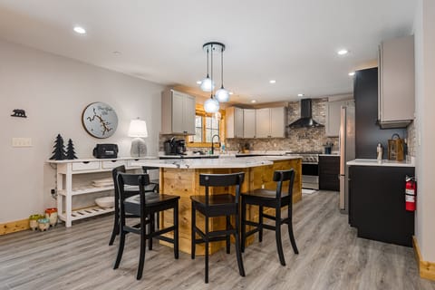Well-equipped kitchen with island seating for five.