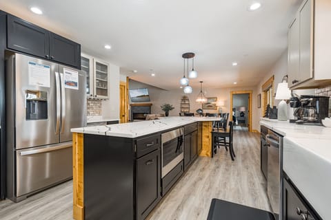 The kitchen has a gas range, ice maker, refrigerator, dishwasher, and under counter microwave.