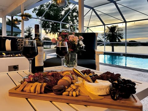 Sip on wine & savor charcuterie board under covered pool patio