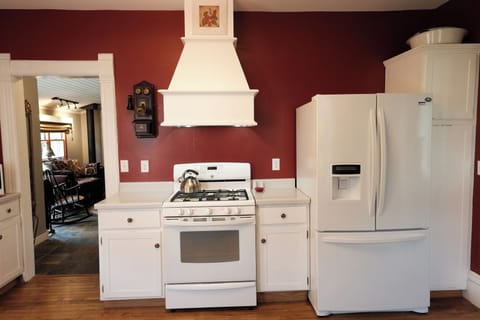Centrally located kitchen with large capacity fridge and pantry