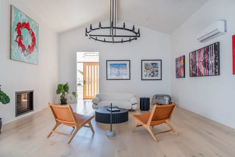 Experience contemporary comfort, where peaceful moments meet the warm glow of a modern fireplace, artful decor, and elegant lighting.