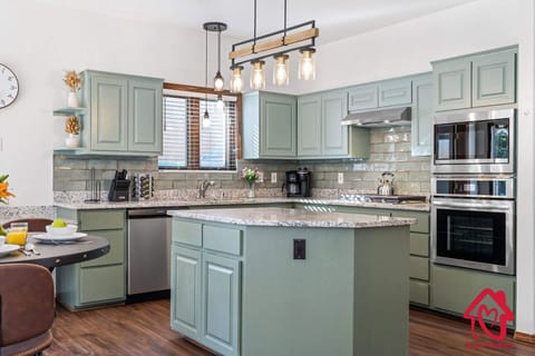 "Elegant Modern Kitchen Design with Stylish Duck Egg Blue Cabinetry and Sleek Stainless Steel Appliances - Perfect Blend of Function and Aesthetics for Your Dream Home"