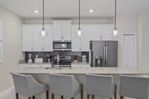 Fully equipped kitchen, stainless steel appliances, and a central island