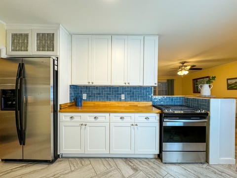 The kitchen features stainless steel appliances and a gas stove