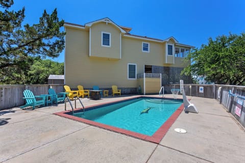 Step inside this beautiful soundside retreat which features a Screened-In Porch, Propane Fire Pit, large Private Pool with a fenced-in patio, and a short drive to the beach and the sound!