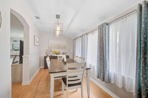 Just off the living area is the beautiful dining room with wall length windows