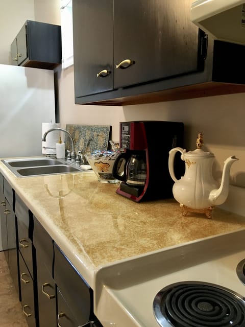 kitchen stocked with various kinds of coffee and tea, as well as various methods for preparing them