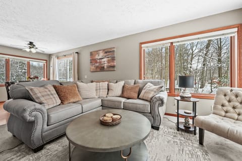 Living Room: Relax in style with stunning forest views and plush seating for memorable gatherings!
