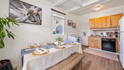 View of the Dining Table in the Kitchen with 4 Burner Stove in the Background