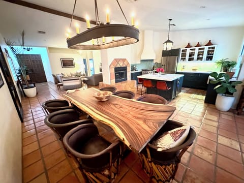 Live Edge Guanacaste Dining Table with Equipale Chairs. Iron Chandalier