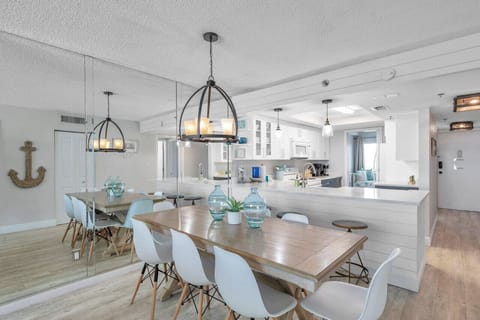Airy dining area set under a statement light, perfect for shared meals and easy conversation.