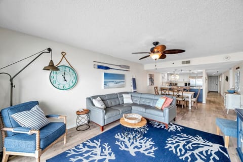 Open living area w/ comfy seating, coastal accents, and an easy flow into dining & kitchen.